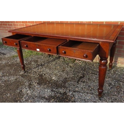 702 - A large Victorian mahogany writing desk, with inset gilt tooled tan leather writing surface, housing... 