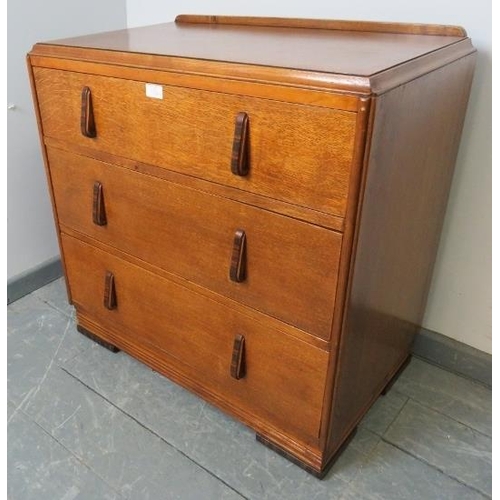 703 - An Art Deco golden oak chest of small proportions, with three long graduated drawers, featuring Maca... 