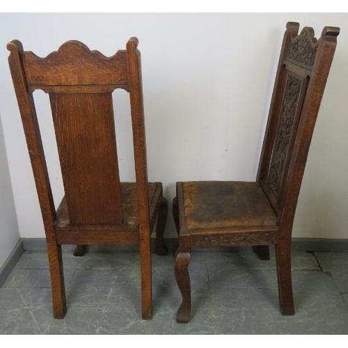 705 - A pair of 19th century Gothic revival oak hall chairs, the ornate relief carving depicting green man... 