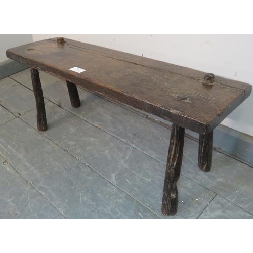 706 - An 18th century oak country made pig bench, on canted tapering supports. 
Condition report: Overall ... 