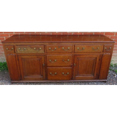 710 - An 18th century English oak dresser with plate-rack over a sideboard base, housing an array of drawe... 