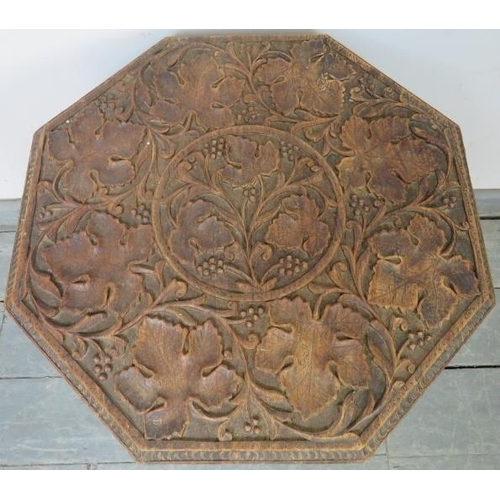 721 - A well carved antique Anglo-Indian hardwood octagonal occasional table, the top raised on a carved a... 