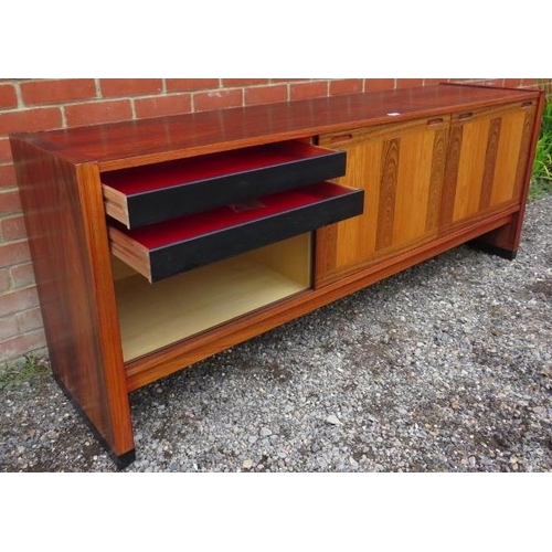 727 - A mid-century tropical hardwood Danish sideboard featuring inlaid specimen woods, the three sliding ... 