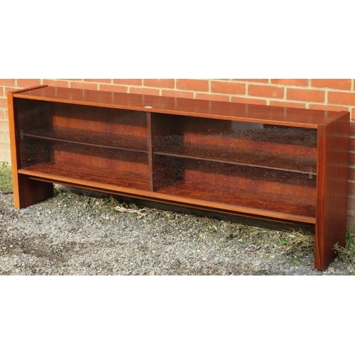 728 - A mid-century tropical hardwood low glazed bookcase with glass sliding doors and height adjustable s... 