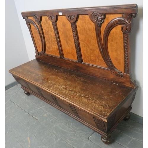 730 - An antique stained pine high-back box settle, ornately carved in the Arts & Crafts taste with depict... 