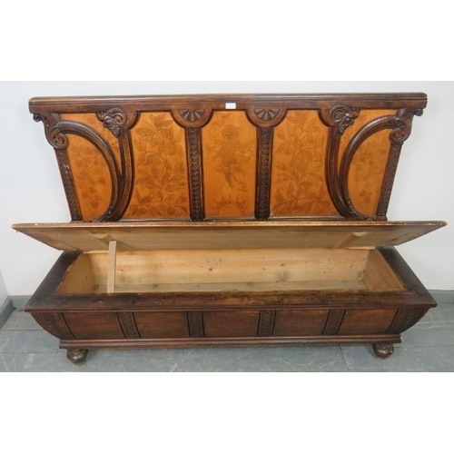 730 - An antique stained pine high-back box settle, ornately carved in the Arts & Crafts taste with depict... 