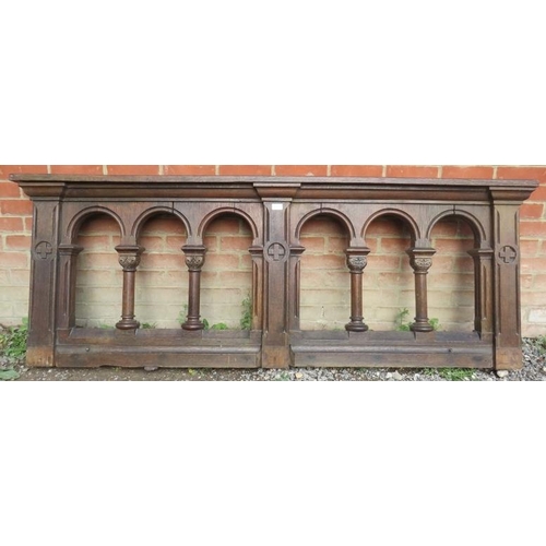 732 - A 19th century oak altar rail featuring relief carving and arches with Corinthian column dividers. 
... 