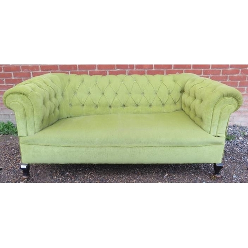 734 - An Edwardian chesterfield two-seater drop-end sofa, upholstered in a gold buttoned material, on ogee... 