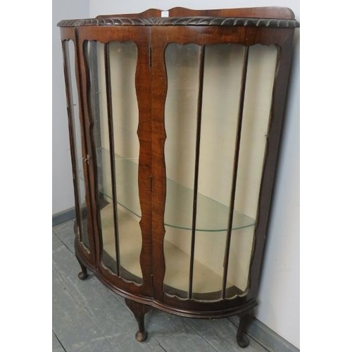 739 - A 1920s mahogany demi-lune glazed display cabinet with gadrooned edge, on cabriole supports. 
Condit... 