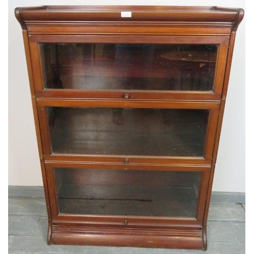 740 - A vintage mahogany Globe-Wernicke style glazed stacking bookcase, of three sections, on a plinth bas... 