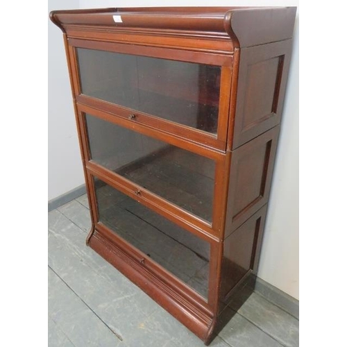 740 - A vintage mahogany Globe-Wernicke style glazed stacking bookcase, of three sections, on a plinth bas... 