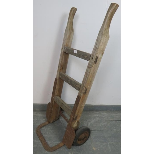 742 - An antique beech and cast-iron railway porter’s sack-barrow with rubber tires. 
Condition report: Ov... 