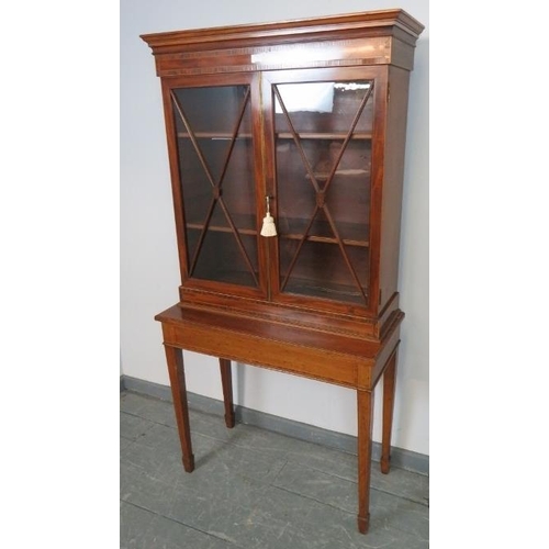 748 - An Edwardian mahogany display cabinet on stand, strung with satinwood and featuring coromandel cross... 