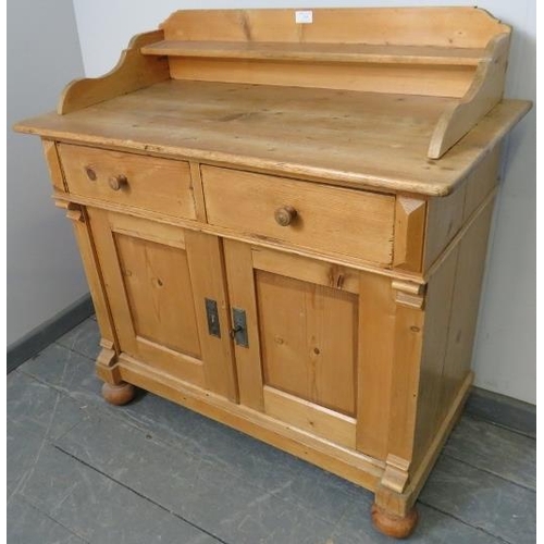 749 - An antique striped pine sideboard with shaped gallery, housing two short drawers and cupboard under ... 