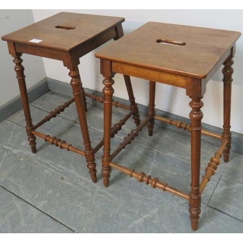 750 - A pair of antique walnut Continental farmhouse stools, with pierced seats, on turned supports united... 