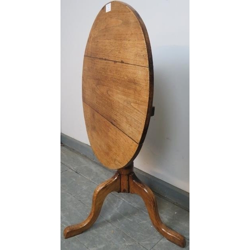 751 - A Georgian elm tilt-top circular wine table, on baluster turned column with splayed tripod base. 
Co... 