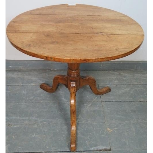 751 - A Georgian elm tilt-top circular wine table, on baluster turned column with splayed tripod base. 
Co... 