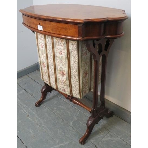 758 - A Victorian walnut shaped sewing table with single frieze drawer and tapestry storage well under, on... 