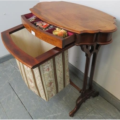 758 - A Victorian walnut shaped sewing table with single frieze drawer and tapestry storage well under, on... 