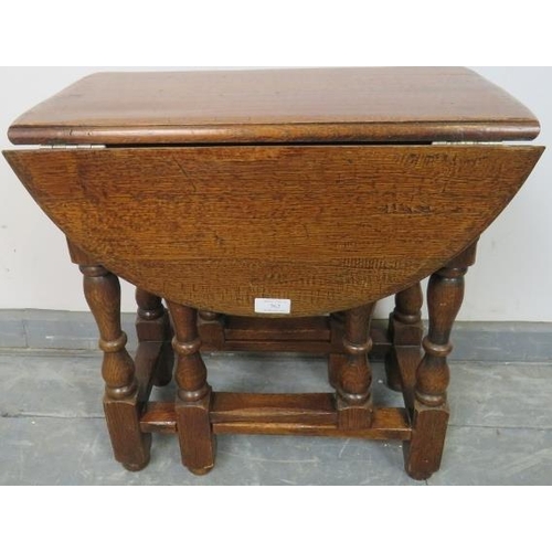 762 - A diminutive oak oval gate leg occasional table in the 18th century taste, on turned and block suppo... 