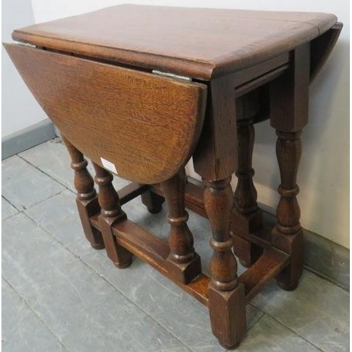 762 - A diminutive oak oval gate leg occasional table in the 18th century taste, on turned and block suppo... 