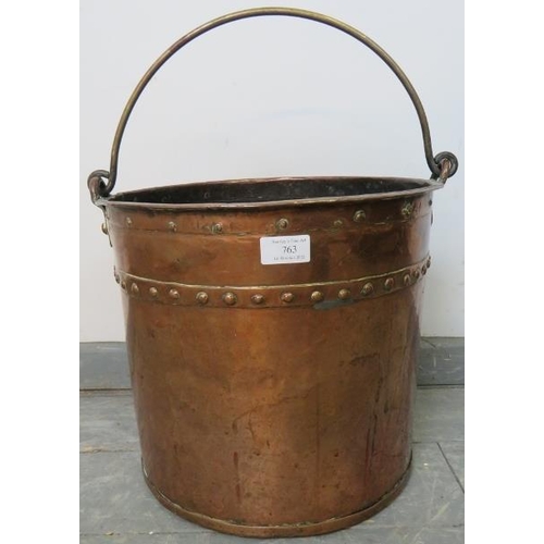 763 - A Georgian riveted copper log bucket with brass handle. 
Condition report: Some old repairs to seams... 