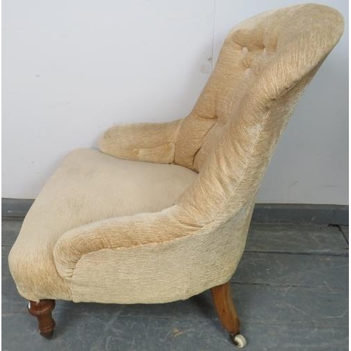 766 - A Victorian nursing chair reupholstered in buttoned cream material, on tapering walnut supports with... 