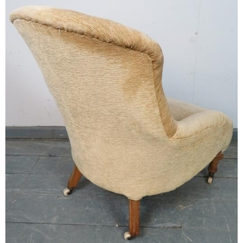 766 - A Victorian nursing chair reupholstered in buttoned cream material, on tapering walnut supports with... 