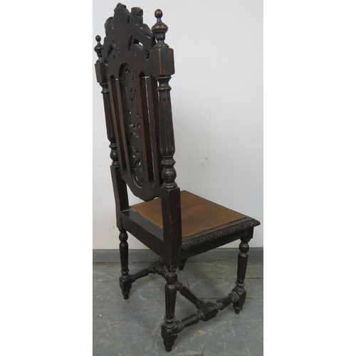 770 - A turn of the century oak hall chair, featuring carved and pierced back rest with heraldic crest dep... 