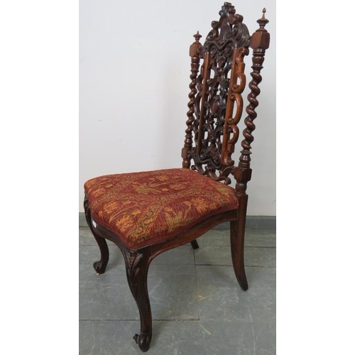 775 - A Victorian rosewood hall chair, the ornately carved and pierced back with barley twist uprights, on... 