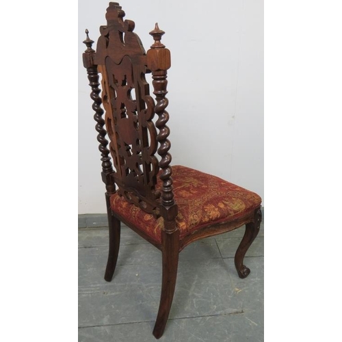 775 - A Victorian rosewood hall chair, the ornately carved and pierced back with barley twist uprights, on... 