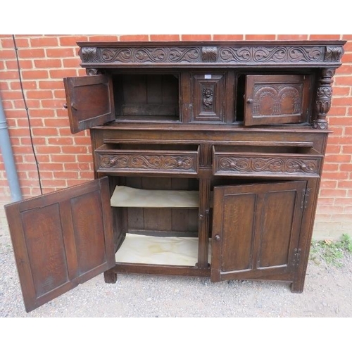 780 - A 19th century oak court cupboard in the 17th century taste, with relief carved frieze and central c... 