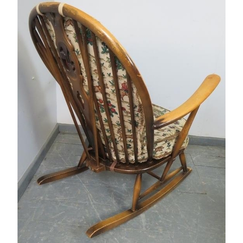 782 - A mid-century elm ‘grandfather’ Windsor rocking chair by Ercol (model 315) with loose cushions uphol... 