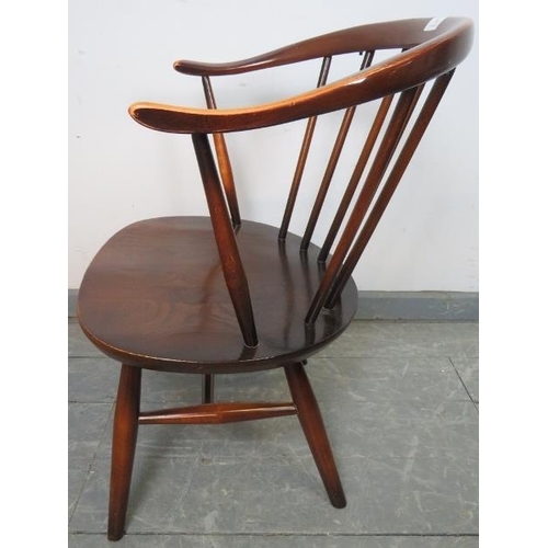 792 - A mid-century elm ‘cowhorn’ tub chair by Ercol (model 333a) on canted supports with an ‘H’ stretcher... 