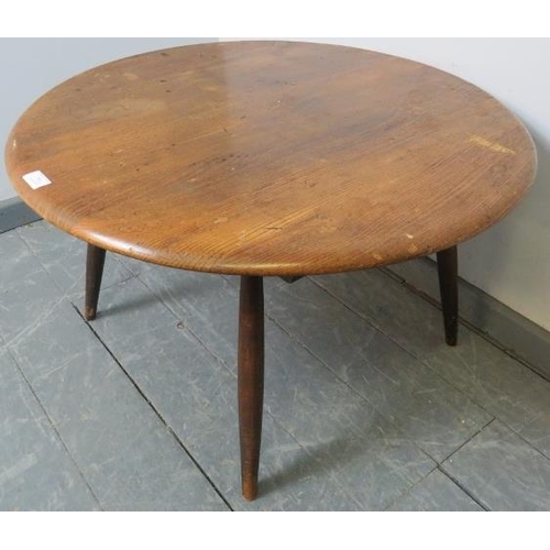 793 - A mid-century elm circular coffee table in the manner of Ercol, on tapering supports.
Condition repo... 