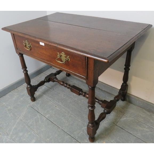 794 - An 18th century oak side table, the single drawer fitted with brass swan neck handles, on turned and... 