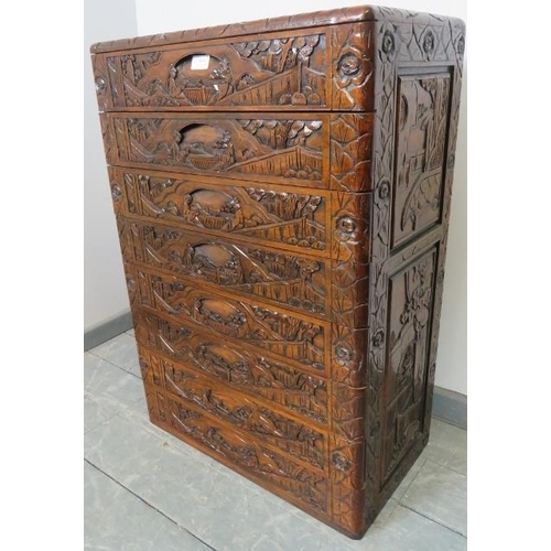 804 - A vintage style Chinese export chest of 8 long drawers with recessed handles, ornately carved with f... 