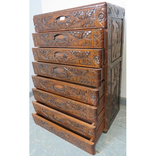 804 - A vintage style Chinese export chest of 8 long drawers with recessed handles, ornately carved with f... 