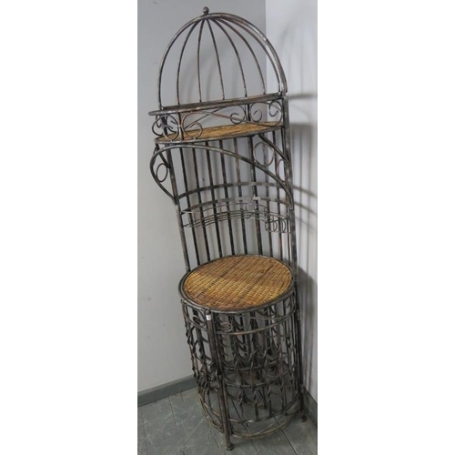 810 - A vintage style wrought iron freestanding wine rack with cane bar area and shelf over, on bun feet. ... 