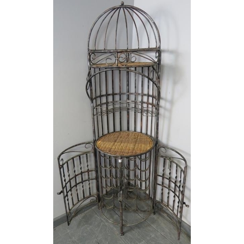 810 - A vintage style wrought iron freestanding wine rack with cane bar area and shelf over, on bun feet. ... 