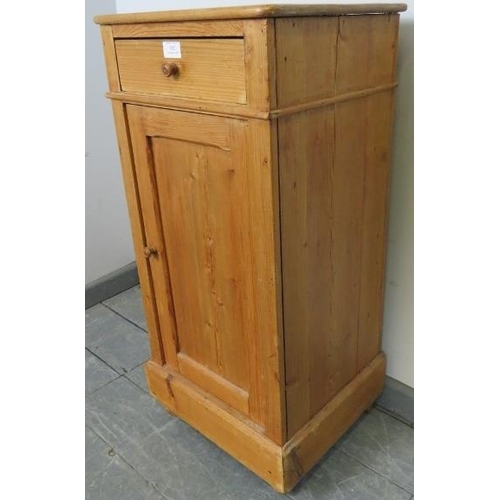 812 - An antique stripped pine bedside cabinet with single drawer and cupboard under with loose shelf, on ... 