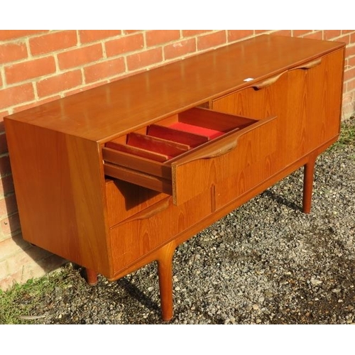 816 - A mid-century teak sideboard by McIntosh, housing three short drawers with scalloped handles and cup... 