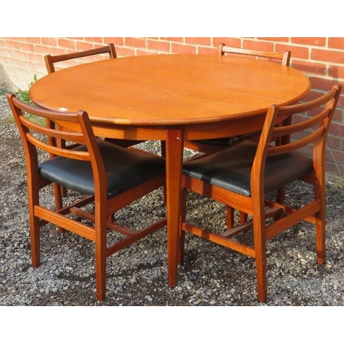 817 - A mid-century teak circular dining table by McIntosh, with central butterfly leaf extension, on tape... 