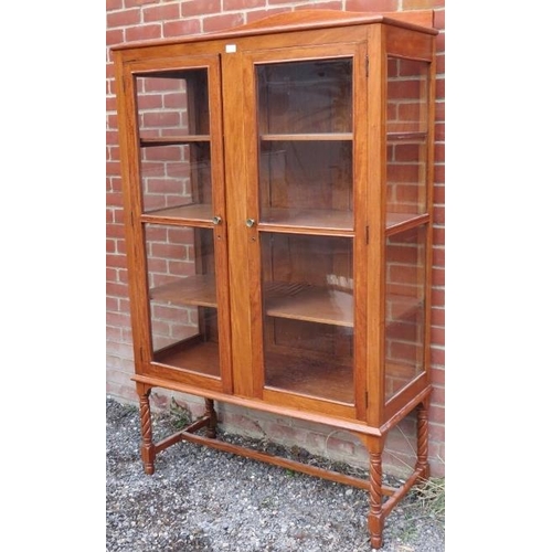 822 - A 19th century acacia wood glazed display cabinet on stand with three fitted shelves, on spiral turn... 