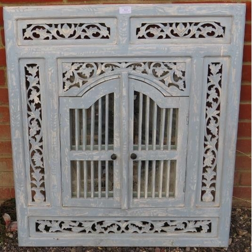 823 - A vintage wall mirror painted distressed blue with foliate carved and pierced surround and arched sh... 