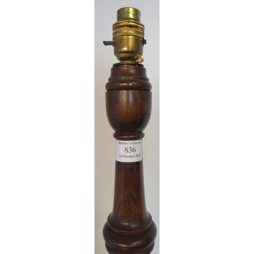 836 - A vintage oak standard lamp with tapering barley twist and baluster turned column on a circular plin... 