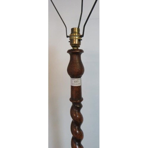 837 - A vintage oak standard lamp with tapering barley twist and baluster turned column on a circular plin... 