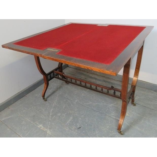 854 - An Edwardian rosewood turnover card table, strung with satinwood and featuring marquetry inlay, the ... 