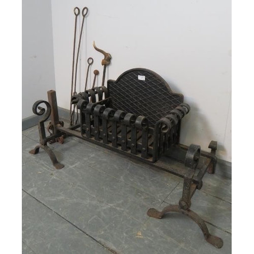 856 - A blacksmith made wrought iron fire basket with scrolled top, on firedog stands with scrolled finial... 