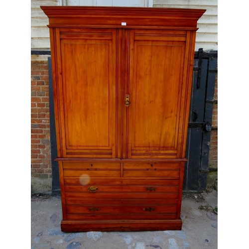 872 - An Edwardian satin walnut linen press with moulded cornice, the reeded and panelled doors opening on... 